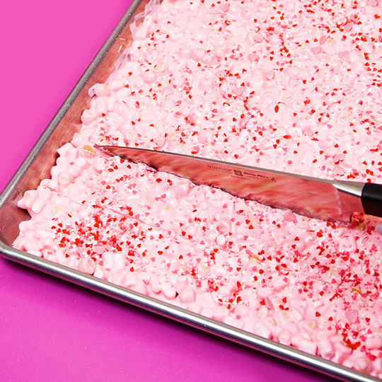 scoring chocolate bark with a knife