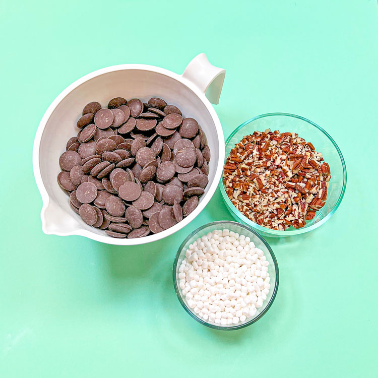 chocolate wafers, pecan, and mini marshmallows in bowls