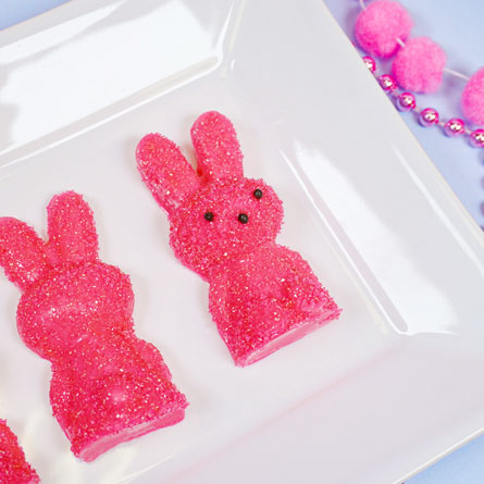 pink chocolate bunny covered in pink sanding sugar on a plate