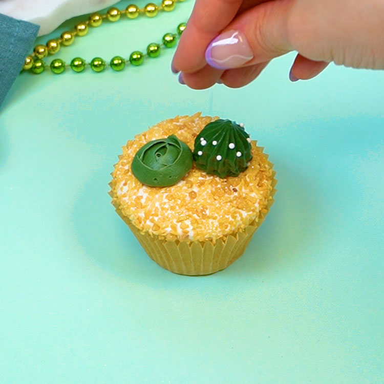 adding sprinkles to buttercream cactus