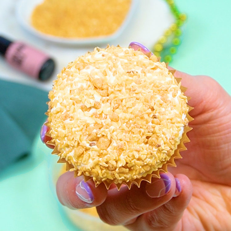 cupcake dipped into coconut crunch