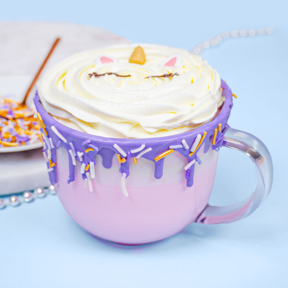 pink cotton candy hot chocolate decorated to look like a unicorn