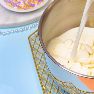 white chocolate wafers and milk in a saucepan