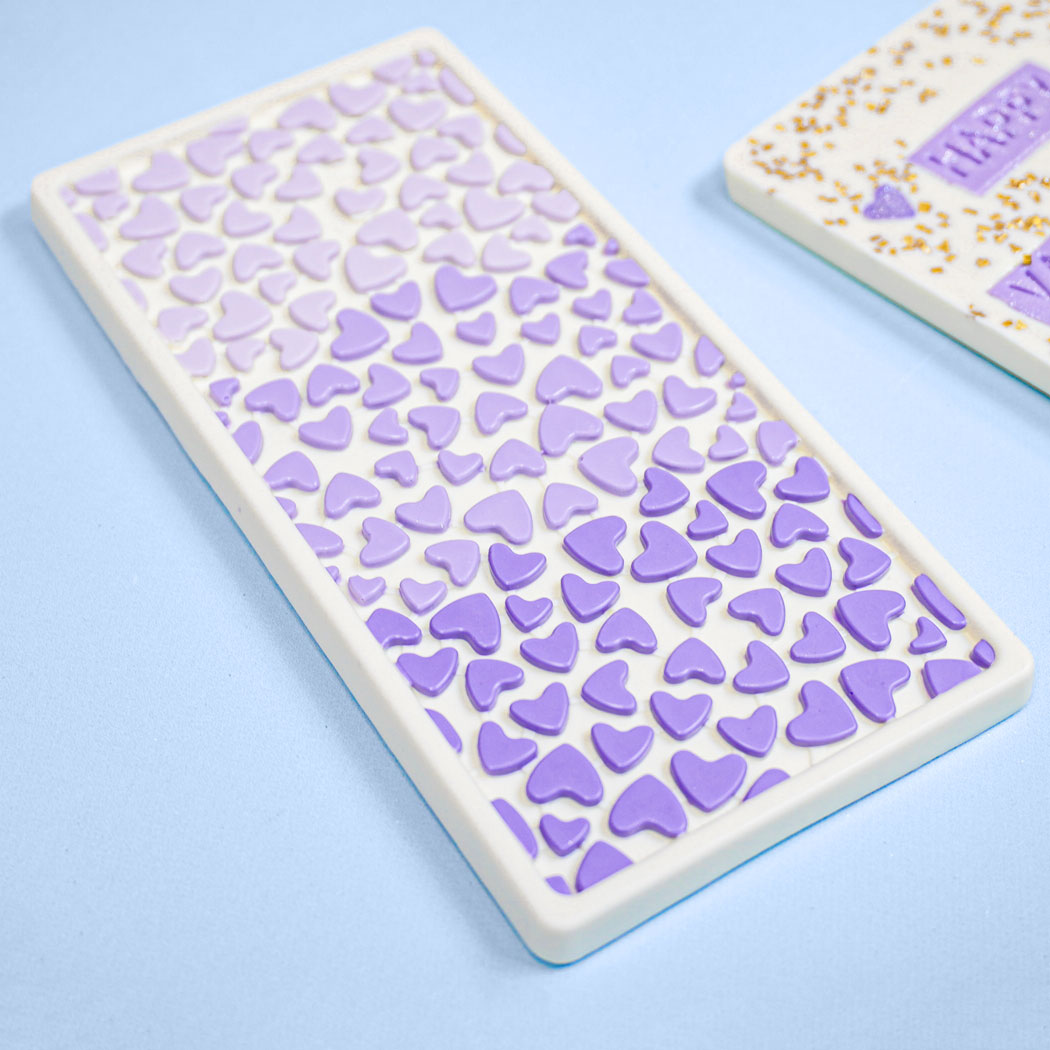 white chocolate bar with purple hearts on the front