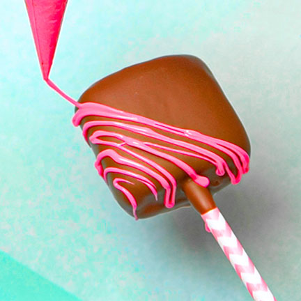 piping melted chocolate onto marshmallow pop
