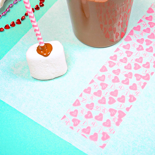 strip of chocolate transfer sheet on parchment paper