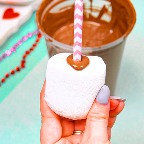 pushing straw into marshmallow