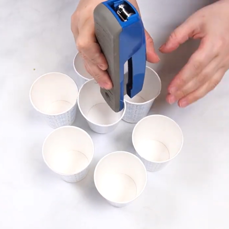 stapling the cups together for a cupcake bouquet