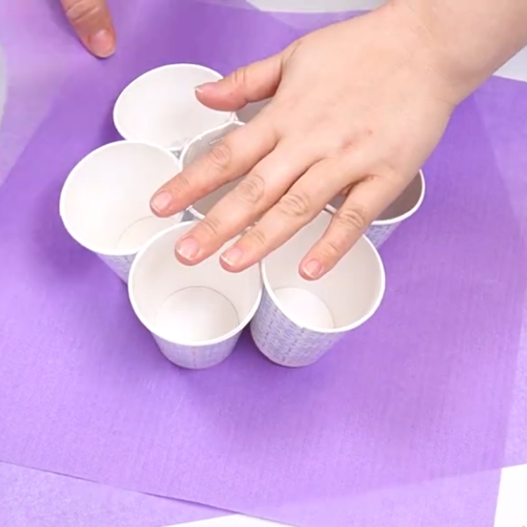 arranging tissue paper cups for a cupcake bouqet