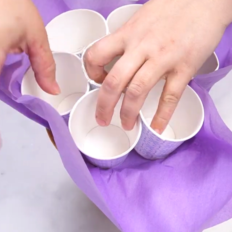 arranging tissue paper cups for a cupcake bouqet
