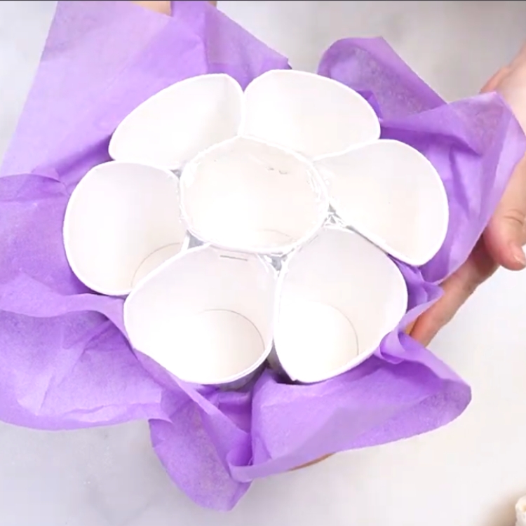 piping buttercream leaves to fill in gaps in cupcake bouquet